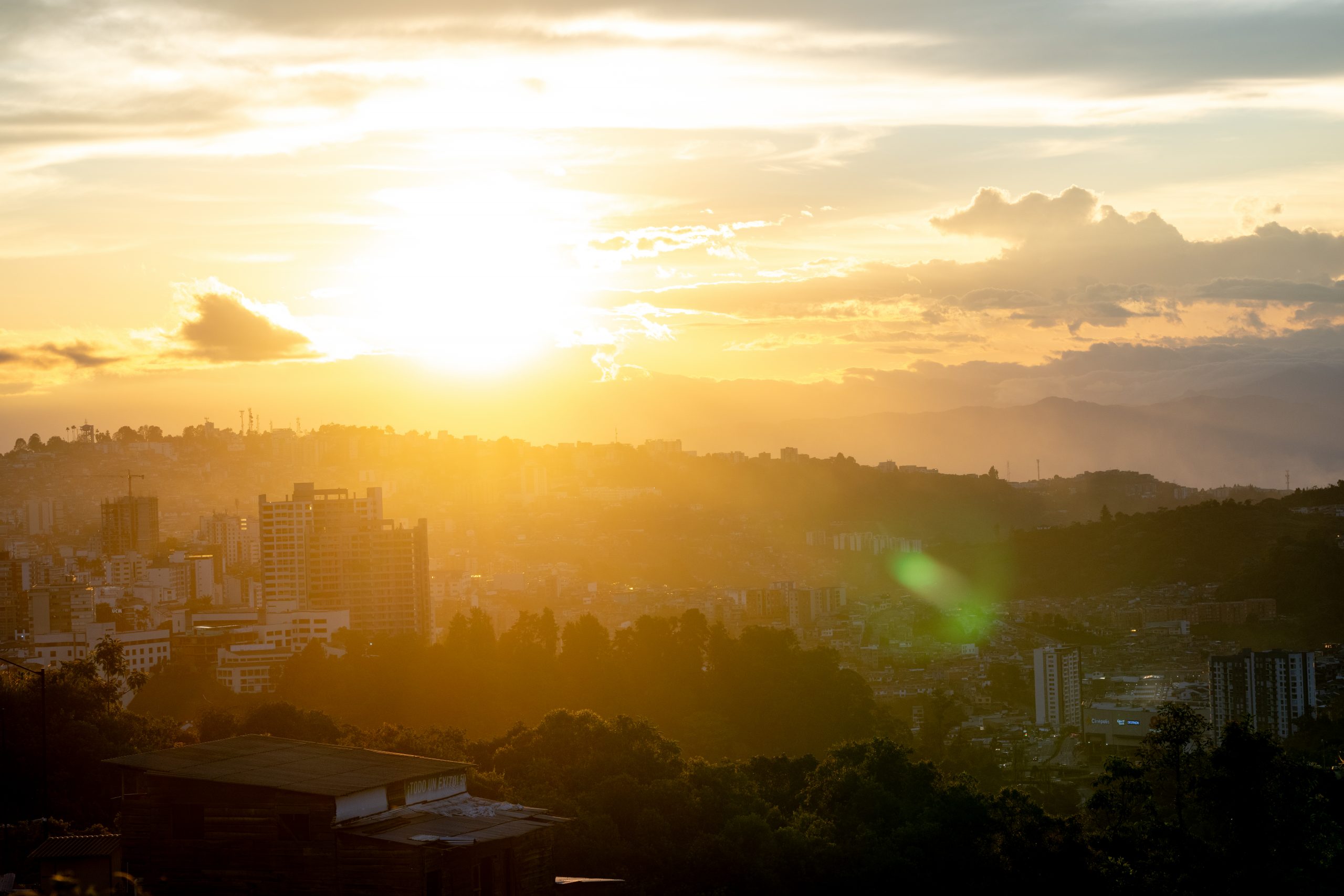 Sunset over Bogot&aacute; skyline, capturing the essence of Taste of Colombia. Scenic view perfect for Scotty Laughland's adventure backdrop. Mountain Bike United.